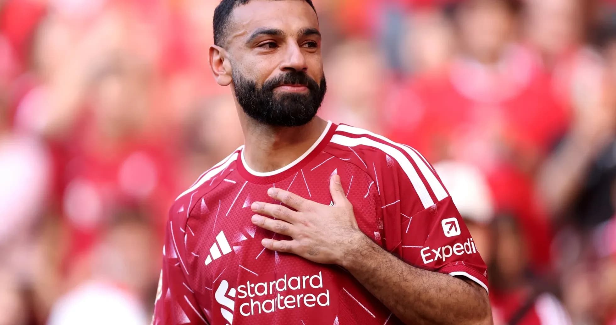 Player in red jersey acknowledging the crowd