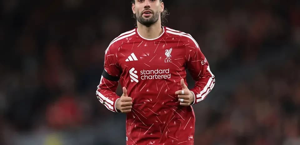 Player warming up in Liverpool kit before match