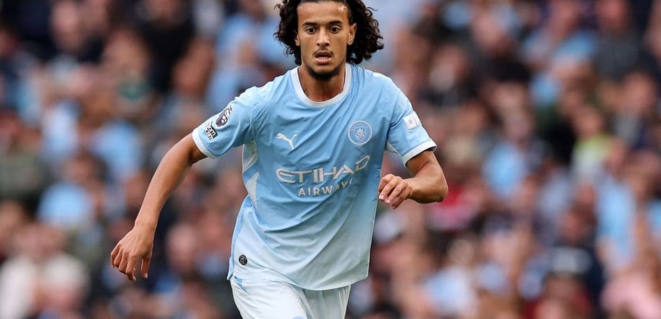 Player running on the pitch in Manchester City kit