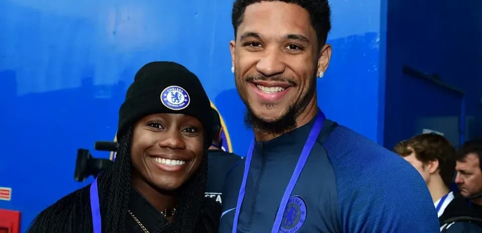 Two Chelsea FC fans posing for a photo