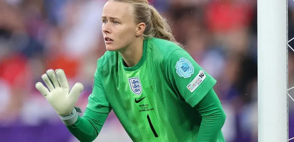 Goalkeeper in green uniform preparing for action