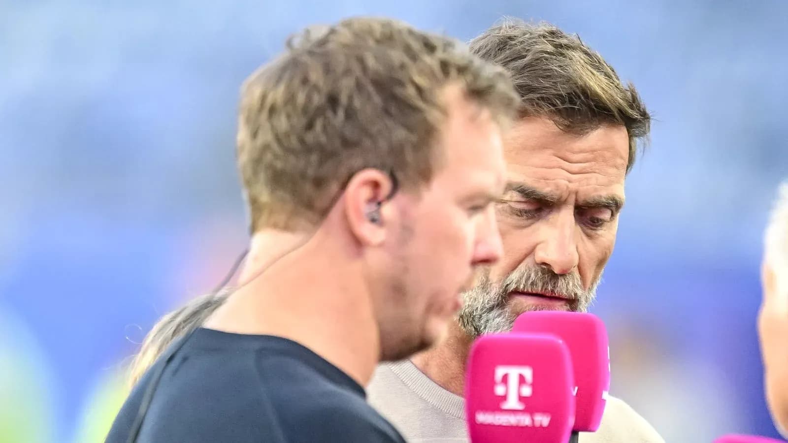 Two commentators discussing near microphones on set