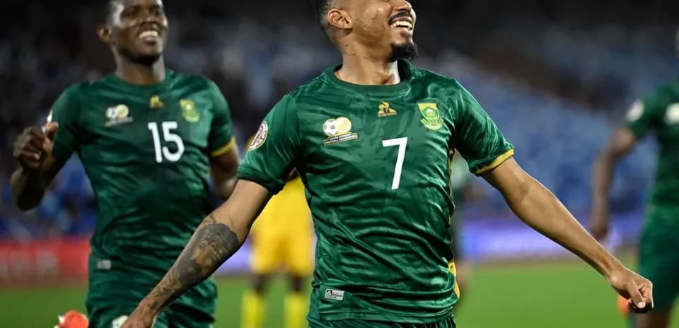 Player celebrating a goal with teammates in match