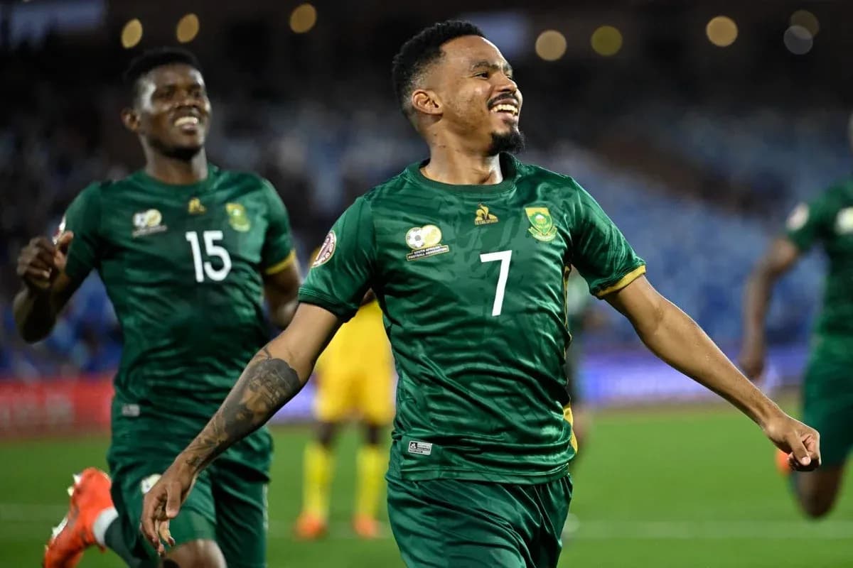Player celebrating a goal with teammates in match