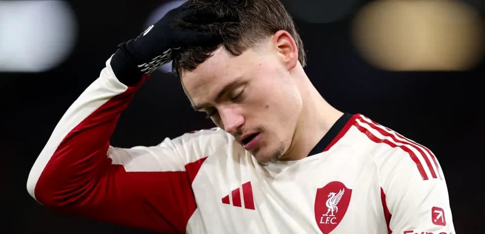 Player in Liverpool kit looking down after match