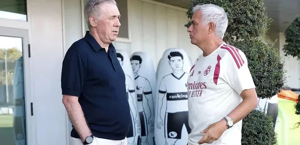 Two coaches talking near training facility