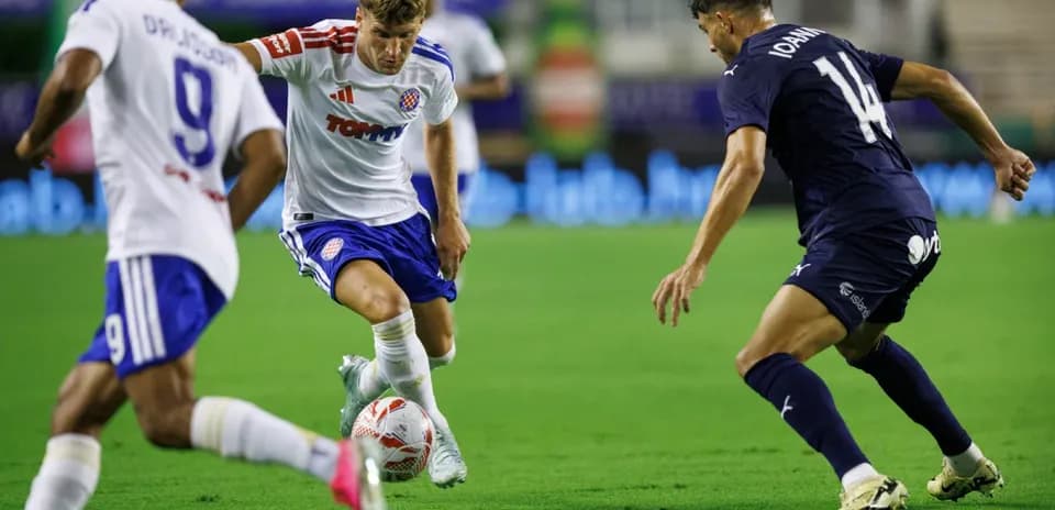 HNK Hajduk Split player dribbling past Pafos defenders