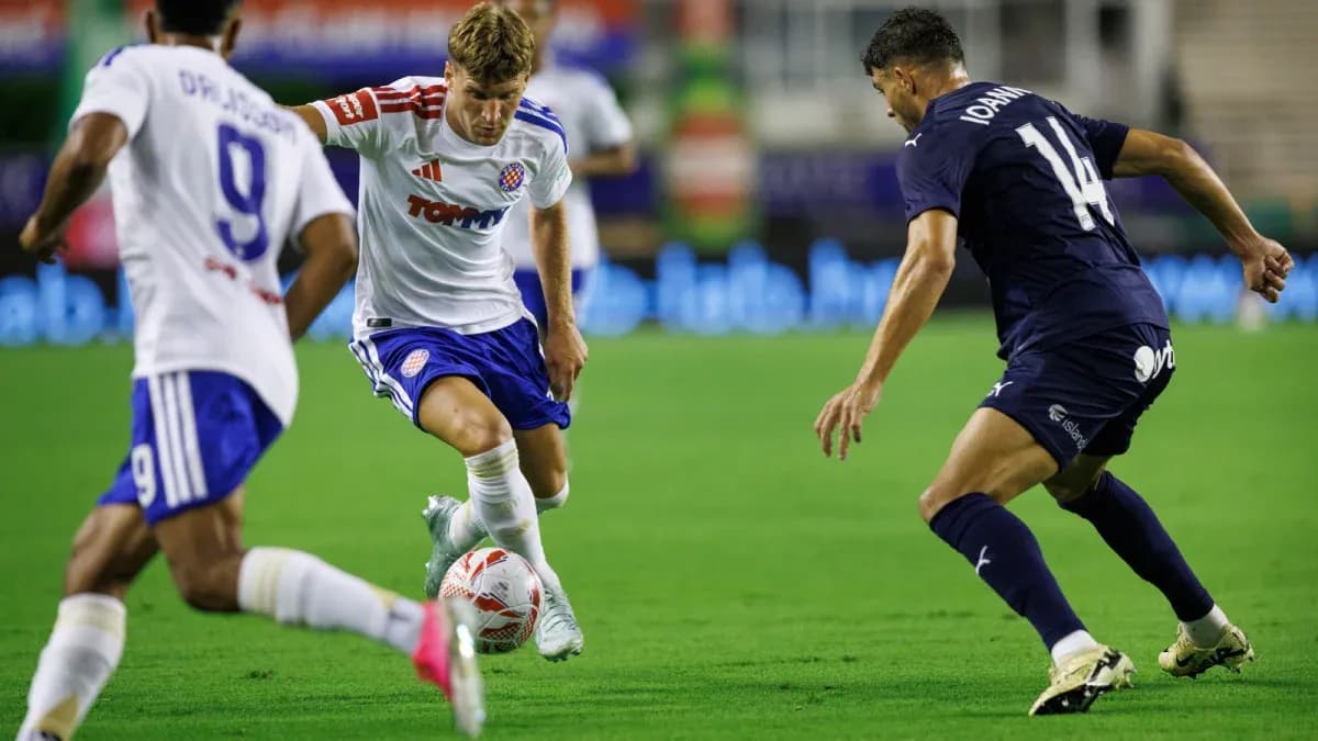 HNK Hajduk Split player dribbling past Pafos defenders