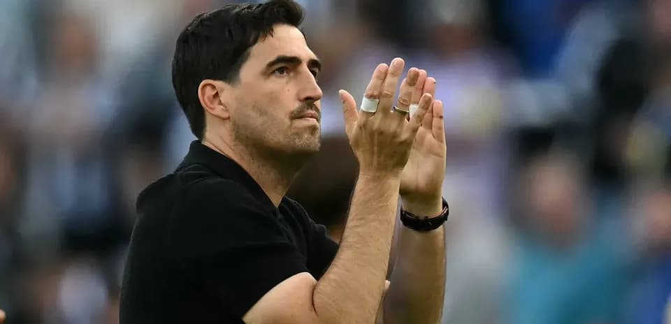 Coach applauding fans during a match