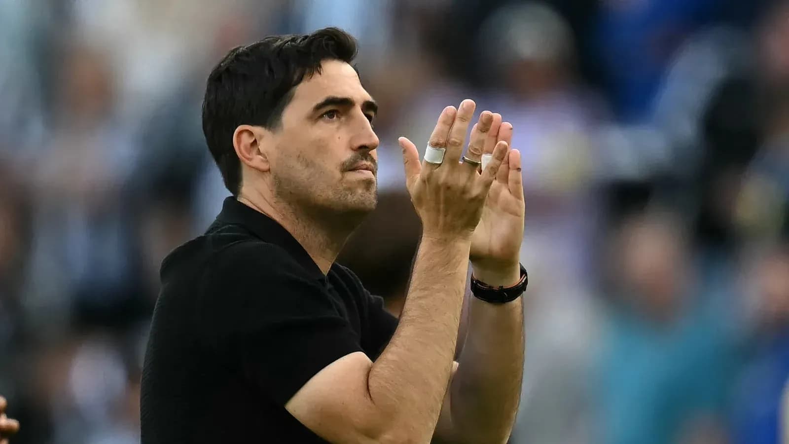 Coach applauding fans during a match