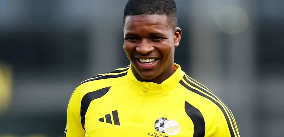 Player smiling during training session in yellow kit