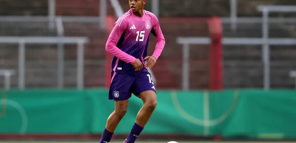 Player in pink and purple uniform during training session