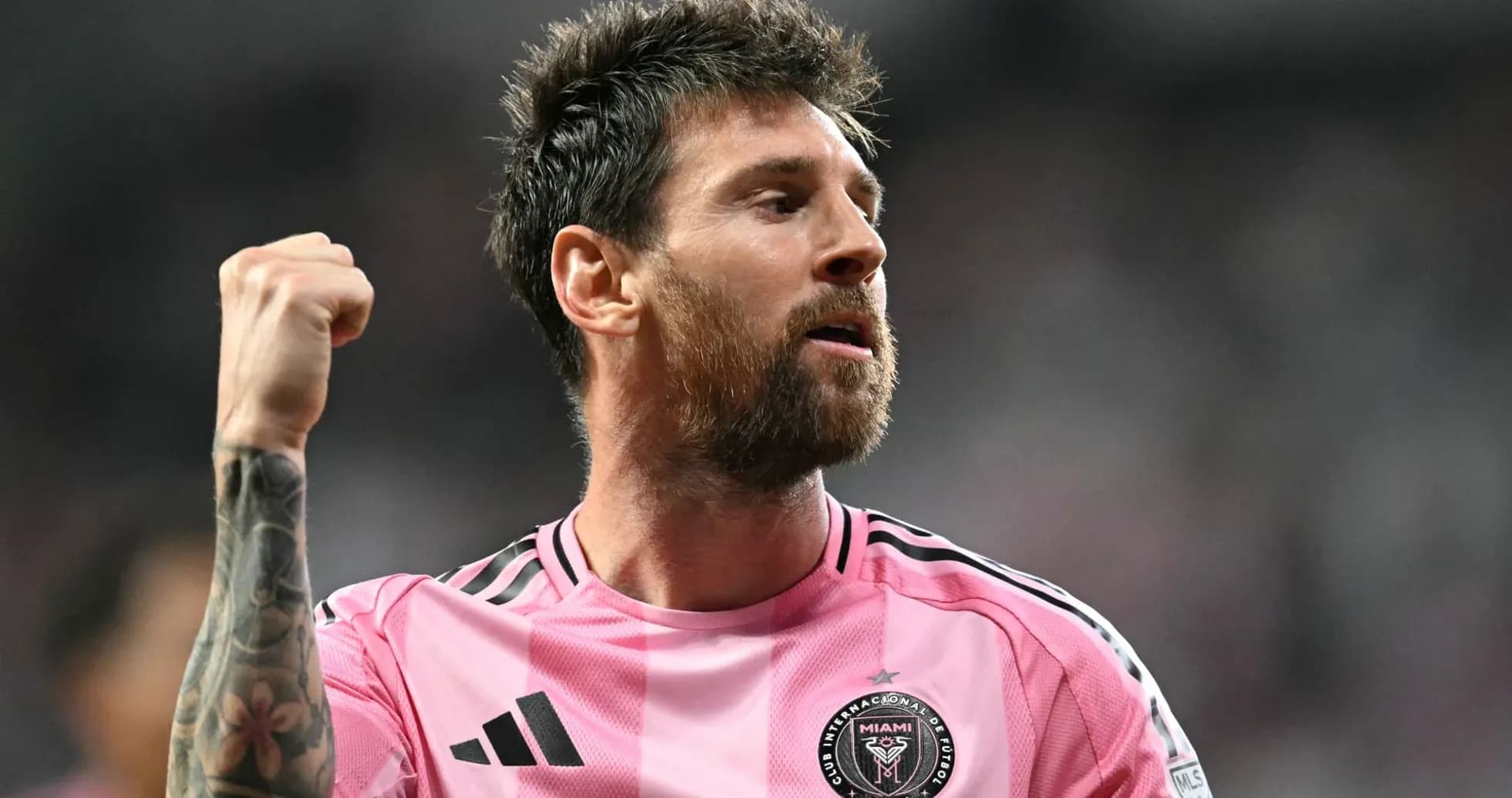 Player celebrating in pink jersey after scoring