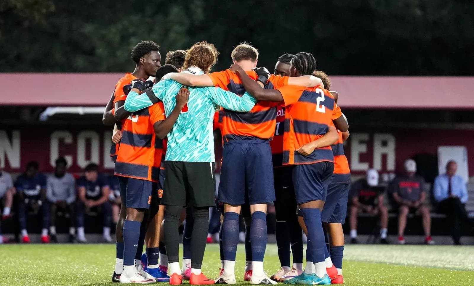 Soccer team huddled together before a match