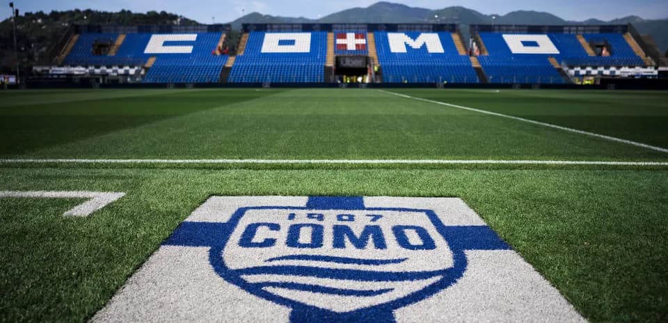 Como stadium with logo on the pitch foreground