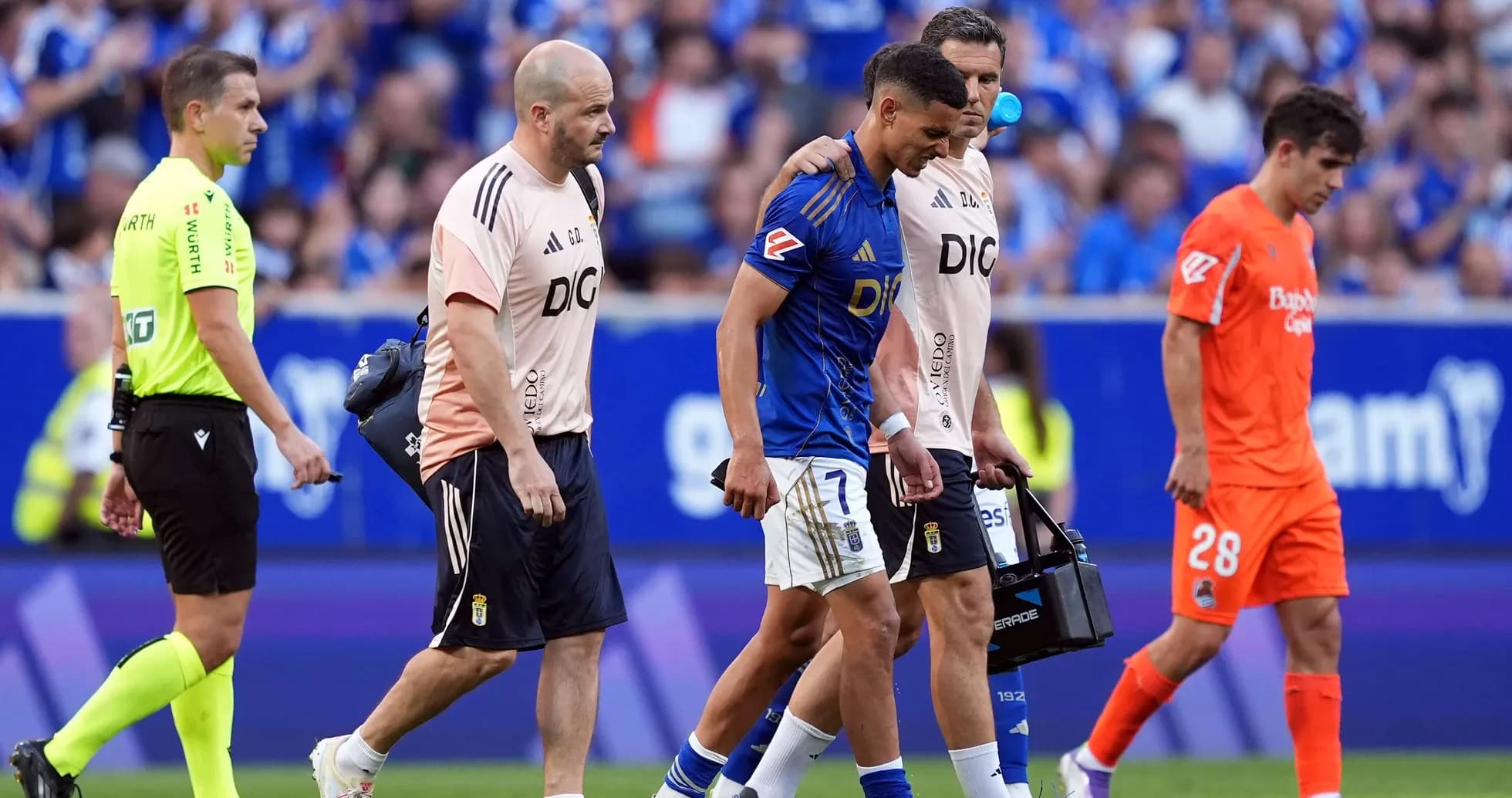 Player being assisted off the field during match