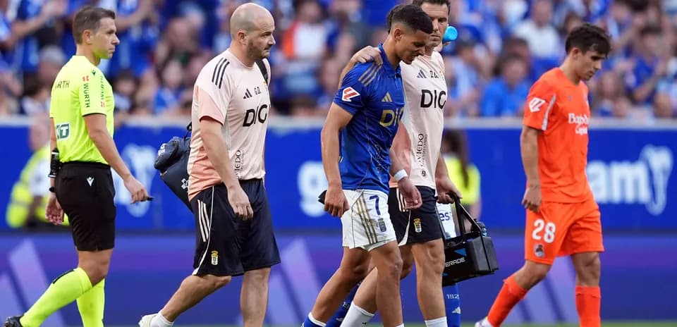 Player being assisted off the field during match