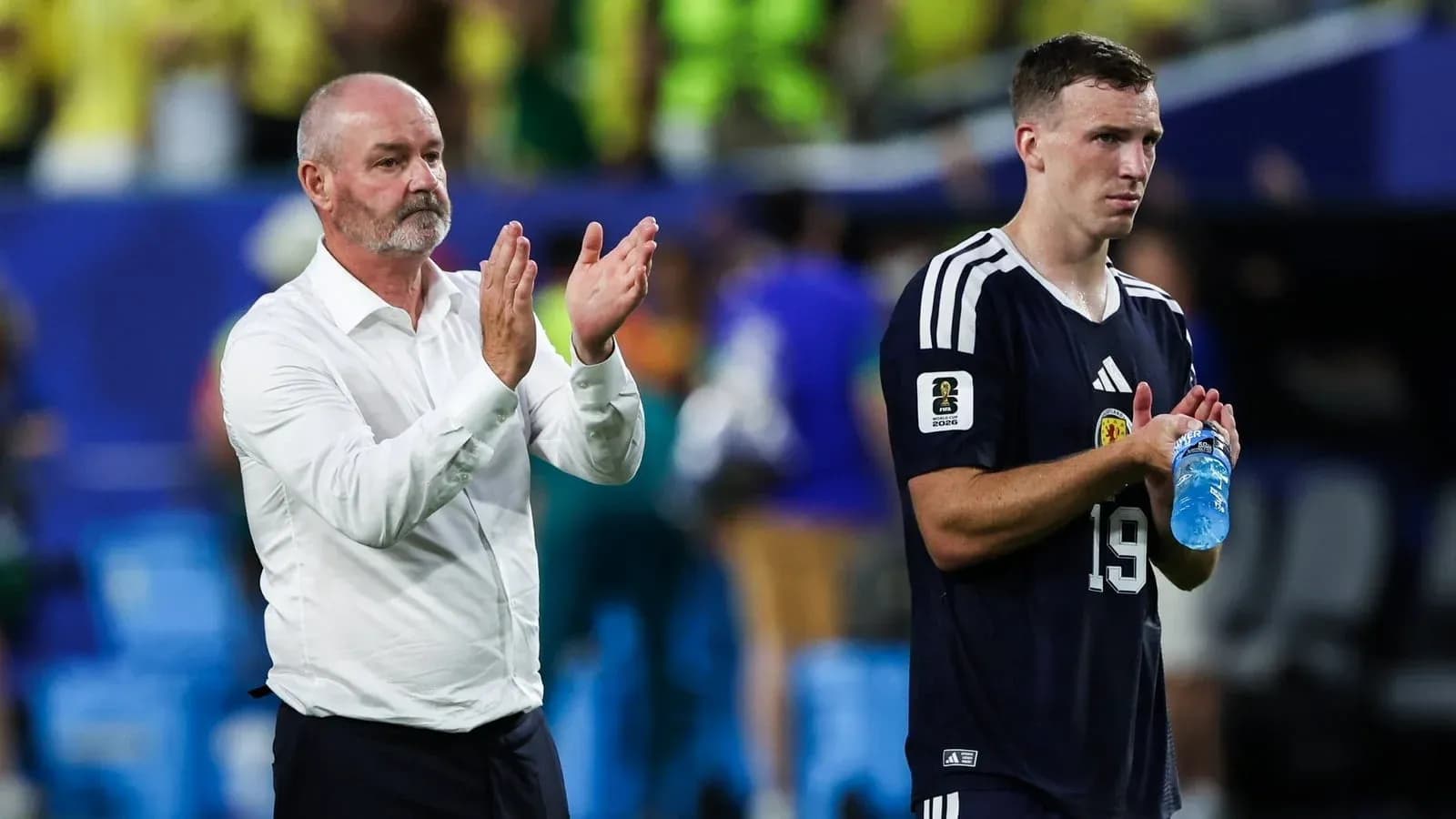 Coach and player applauding after a match