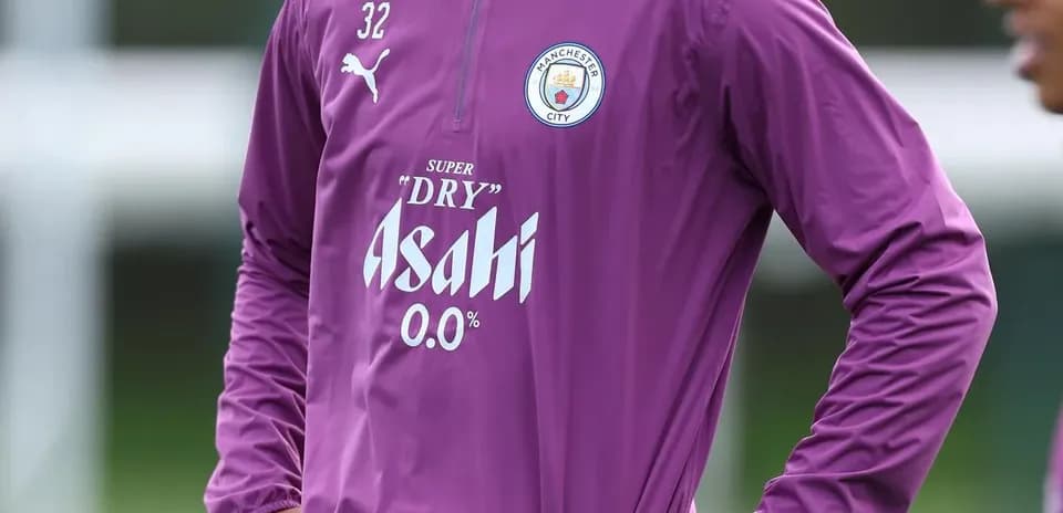 Player in Manchester City training attire on pitch
