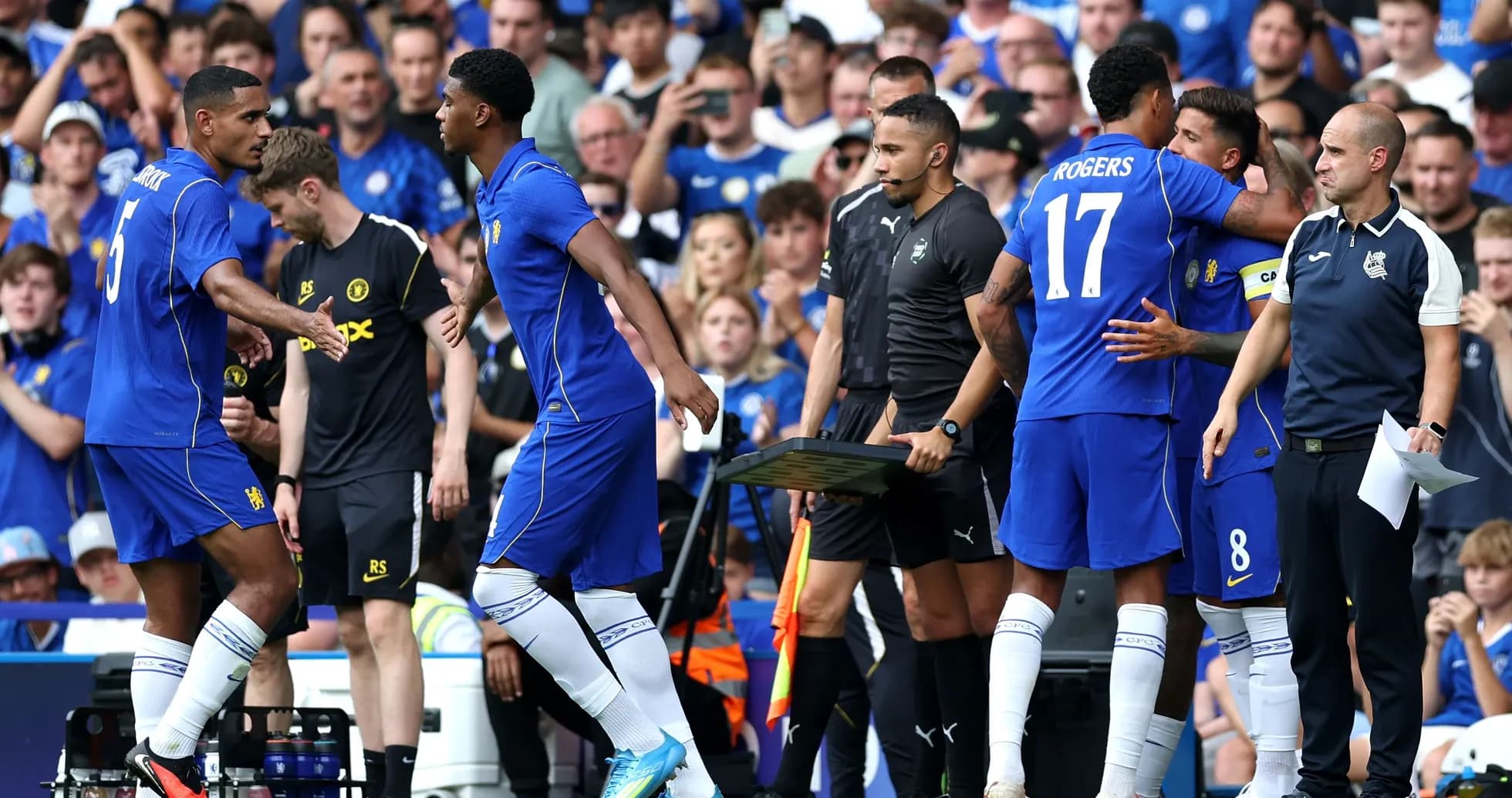 Players making substitutions during a football match