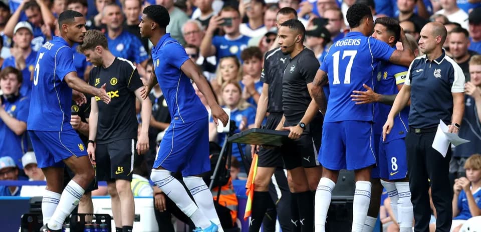 Players making substitutions during a football match
