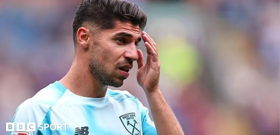 Player touching forehead during match at stadium