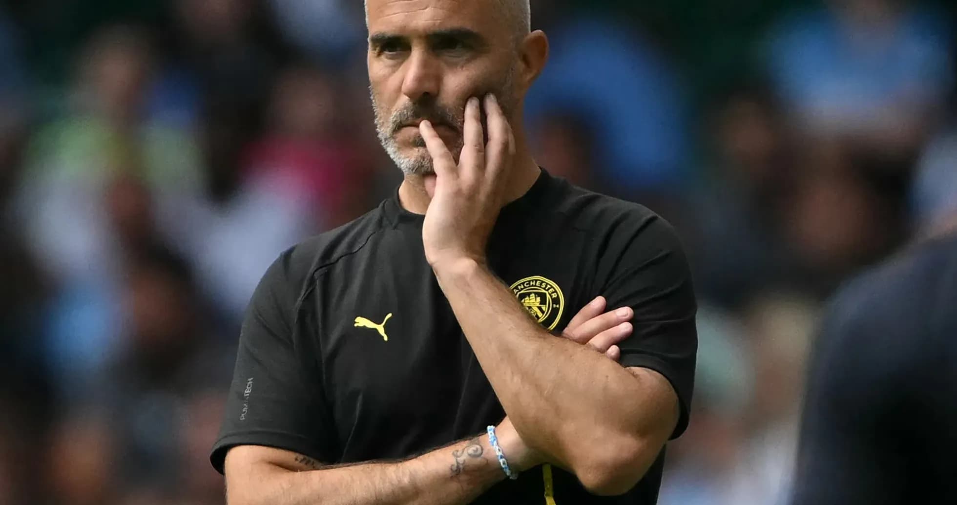 Manager observing match with hand on chin