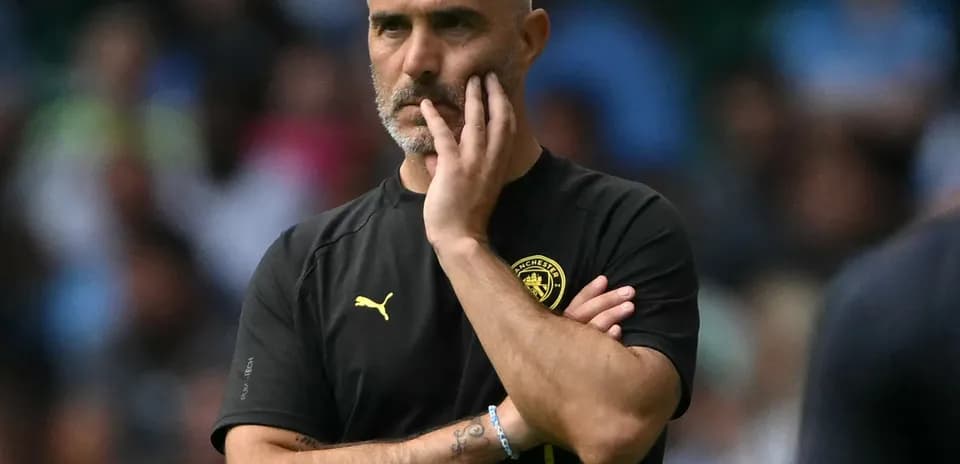 Manager observing match with hand on chin