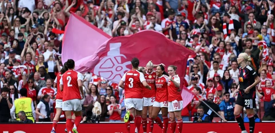 Arsenal women's team celebrating a goal with fans