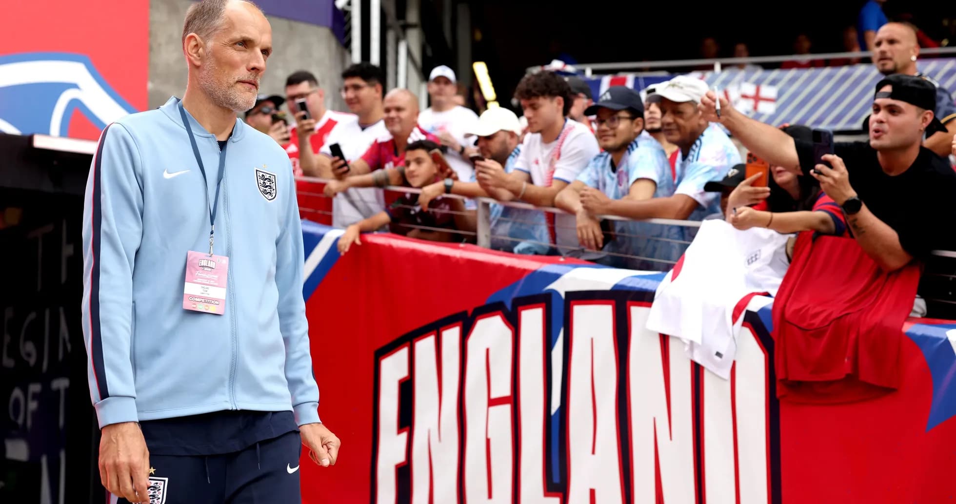 Coach walking past fans before match in stadium
