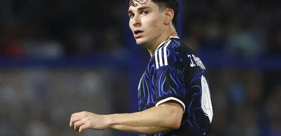 Player in dark jersey looking back during match