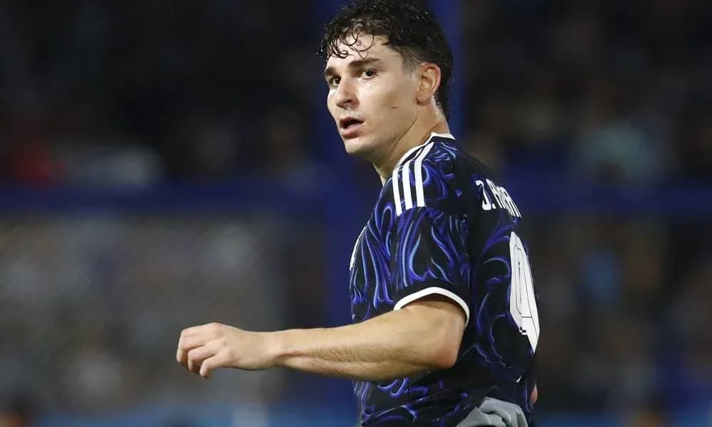 Player in dark jersey looking back during match