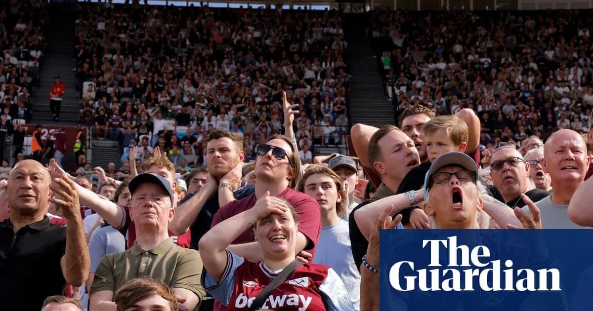 Crowd of fans reacting during a football match