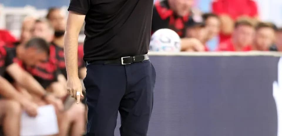 Coach directing players during a soccer match