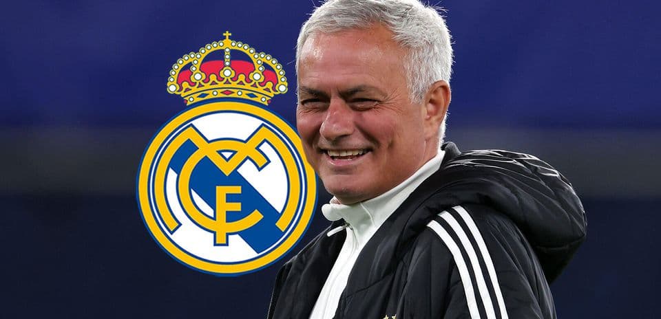 Coach smiling with Real Madrid logo in background