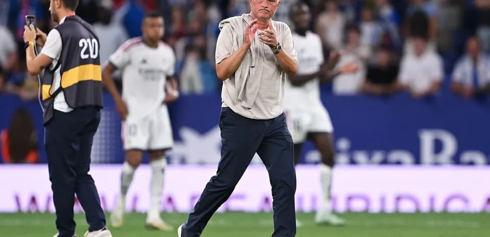 Manager applauding on the sidelines during match