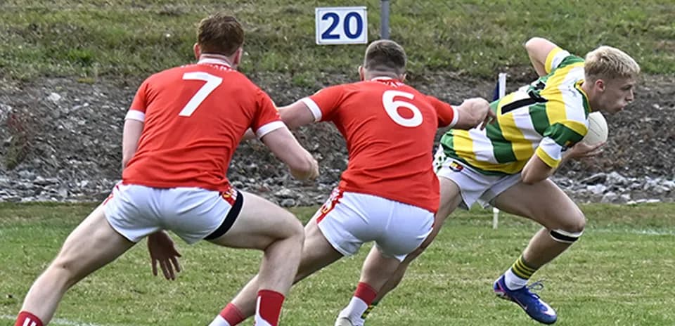 Player in green and yellow evading two opponents