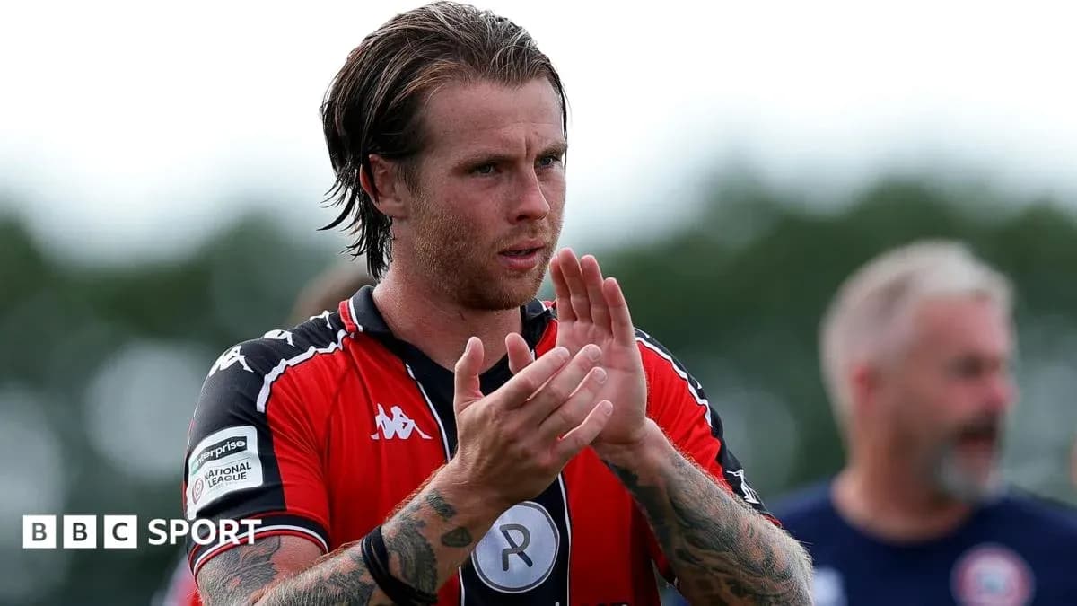 Player applauding fans after match wearing red jersey Player applauding fans after match wearing red jersey