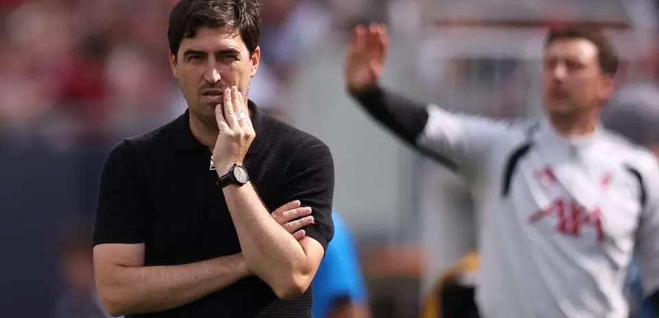 Coach observing match with hand on chin