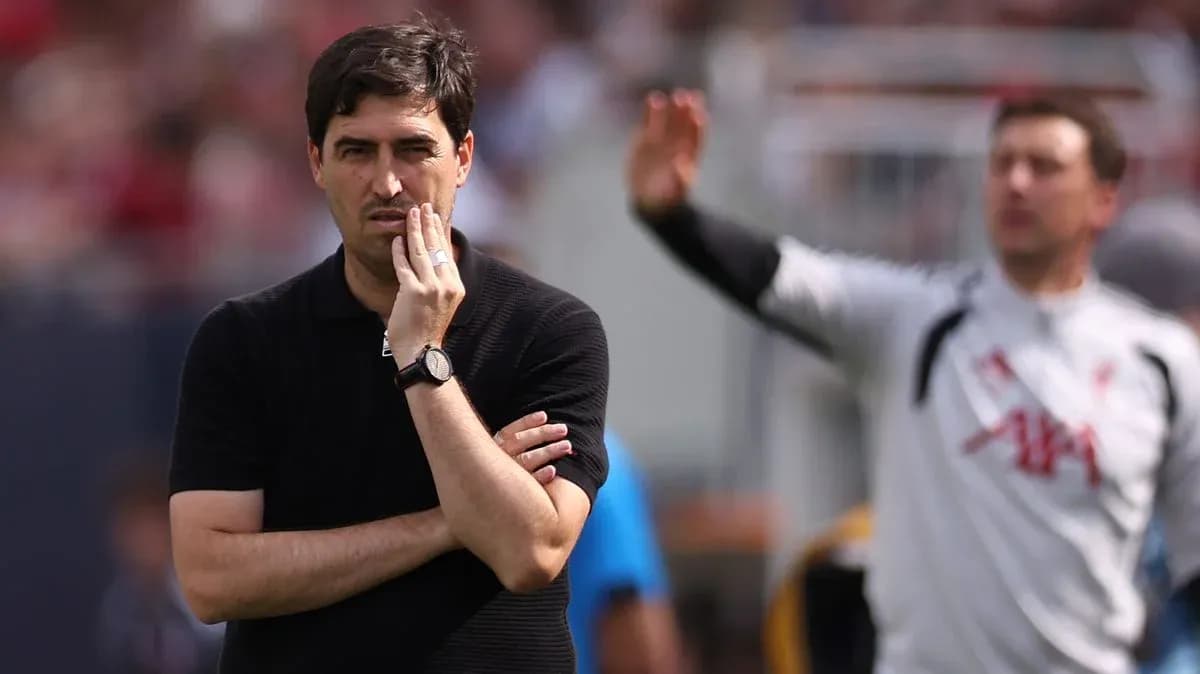 Coach observing match with hand on chin