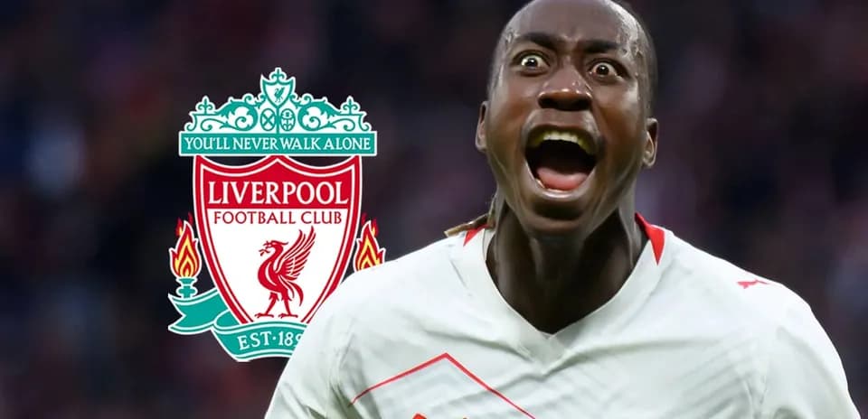Player celebrating with Liverpool logo in background
