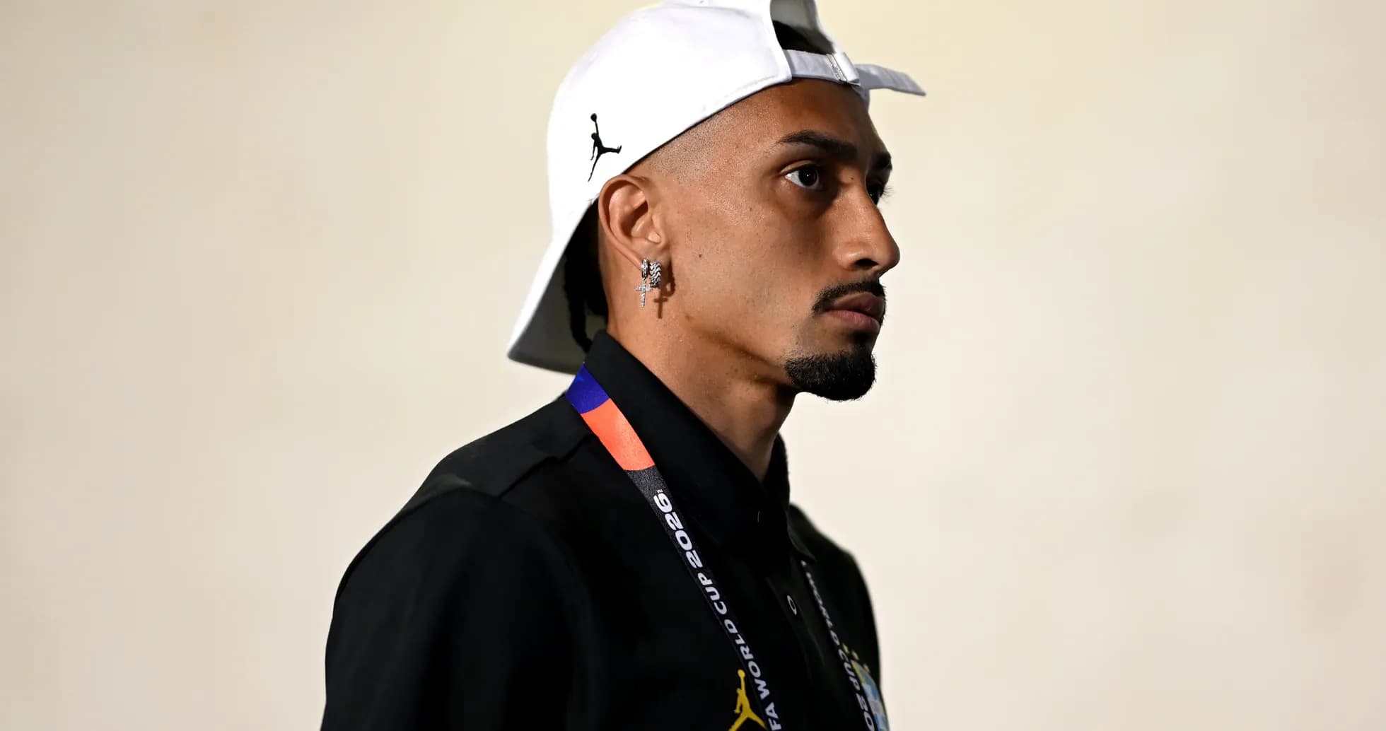 Person wearing a cap and FIFA World Cup lanyard