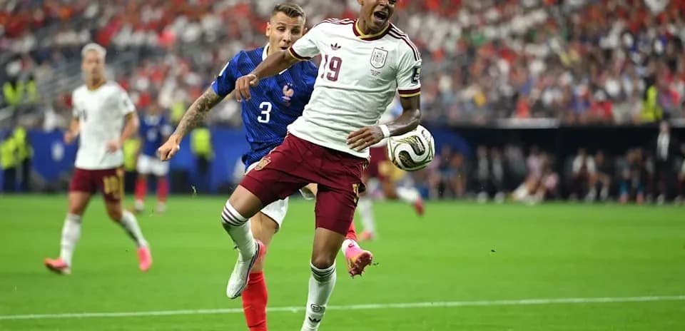 Player from Spain evading a tackle from France