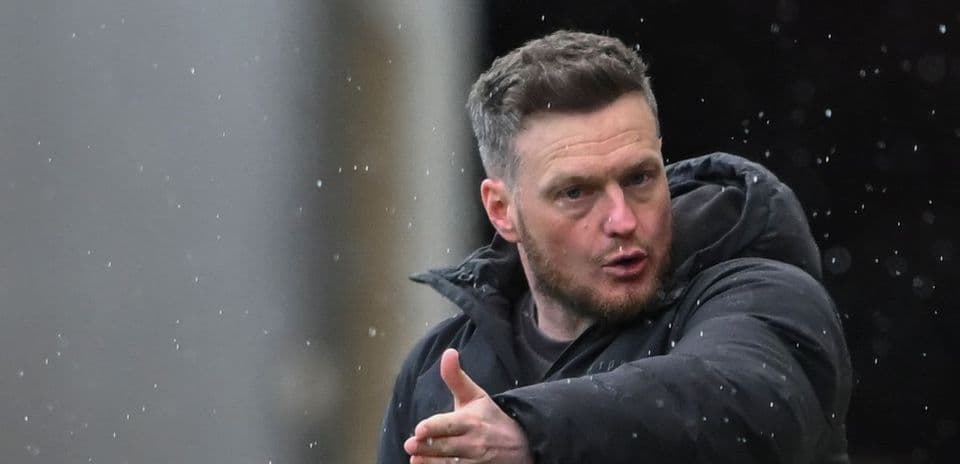 Manager giving instructions during rainy match
