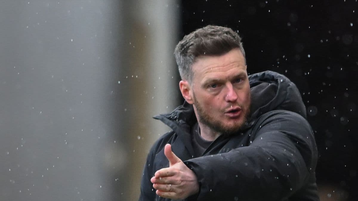 Manager giving instructions during rainy match
