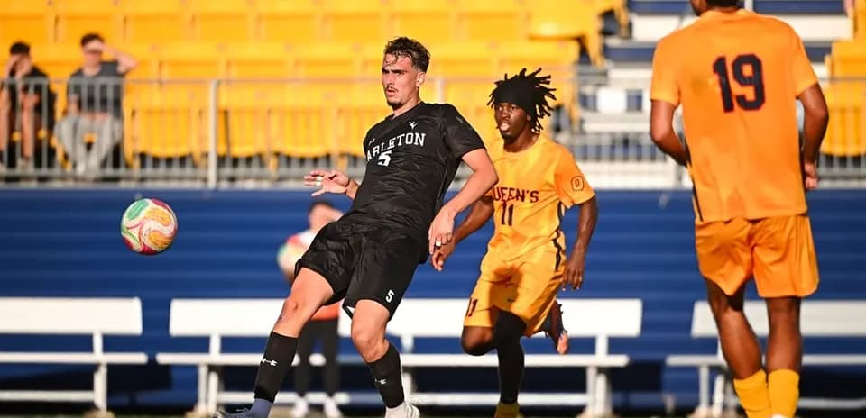 Player passing the ball during soccer match