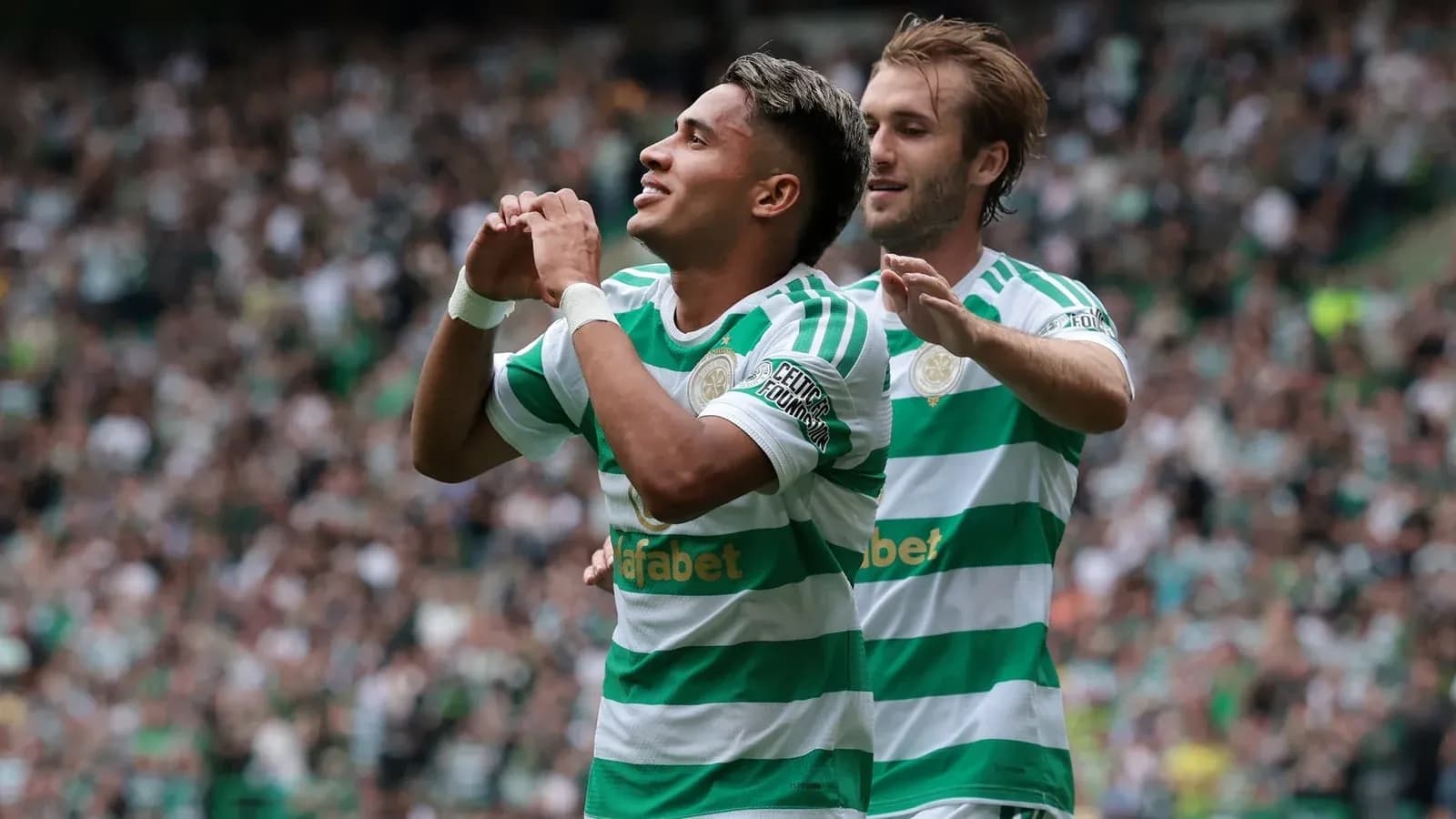 Celtic players celebrating a goal on the pitch