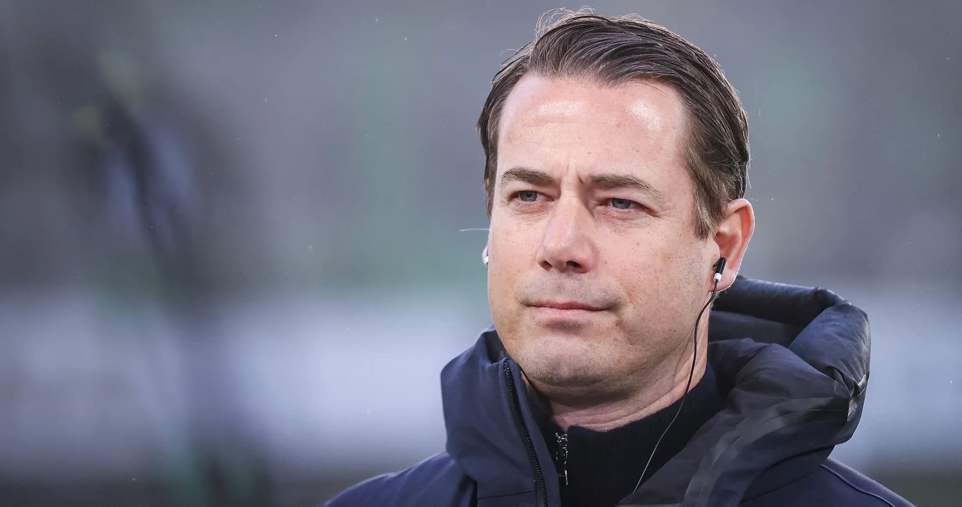 Coach wearing an earpiece during match preparations