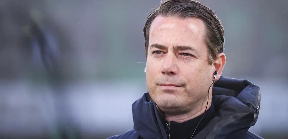 Coach wearing an earpiece during match preparations