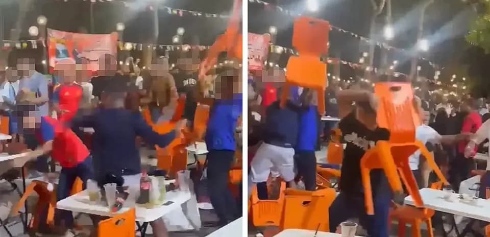 Crowd throwing chairs during a chaotic event